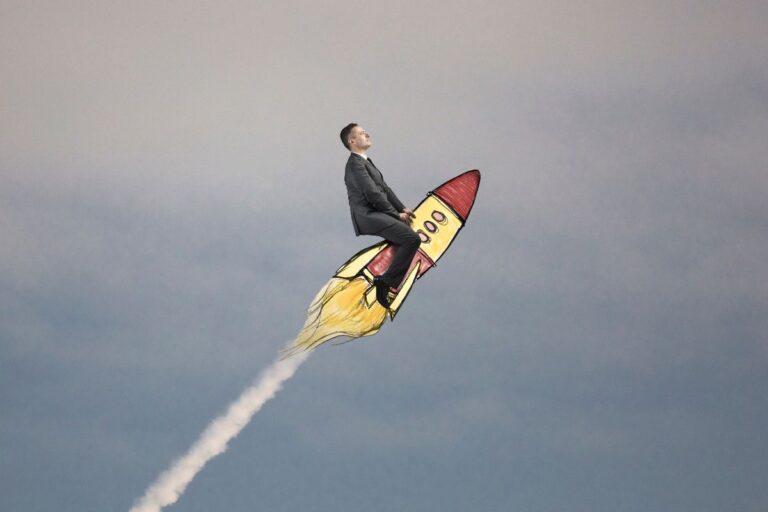 A man in a business suit riding a cartoon rocket through a cloudy sky.