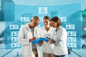 A group of three dentists in lab coats are collaborating. Their backs are turned on an overly hierarchical organization map.